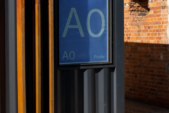Urban poster mockup on a metal stand against a brick wall texture, with vibrant lighting suitable for graphic designers.