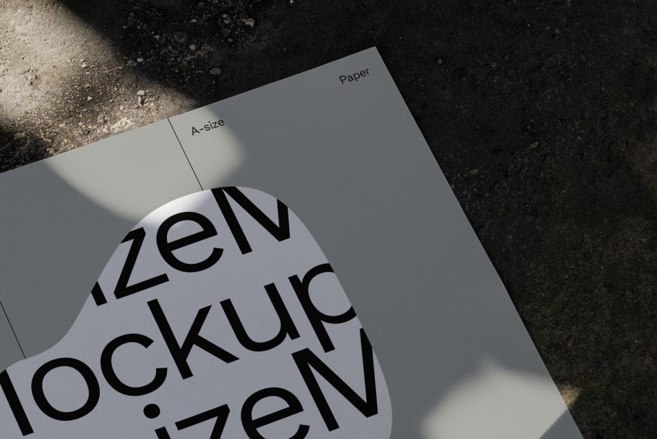 A-size paper mockup with realistic shadow overlay for showcasing font and graphic design on a textured ground surface.