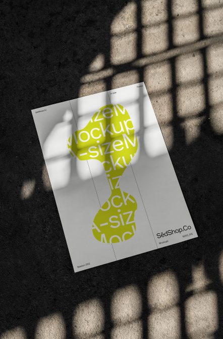 A4 poster with lime green circular graphic casting shadow on pavement