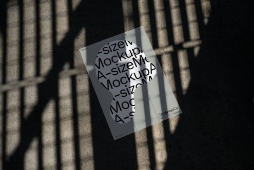 A-size poster mockup on textured ground with shadow overlay. Ideal for presenting graphic design projects. Keywords: mockup, poster, graphic design, template.