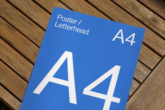Blue A4 poster mockup on wooden background for designers showcasing letterhead, print design, graphic layout, template presentation.