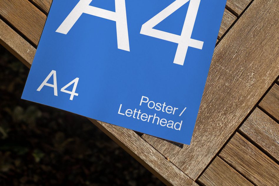 Blue letterhead mockup featuring large white A4 typography on wood
