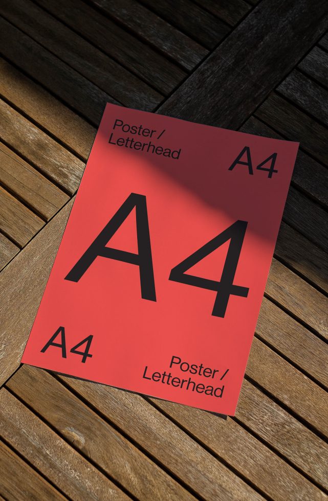 A4 paper mockup template for poster/letterhead design, resting on a wooden floor, angled view for presentations.