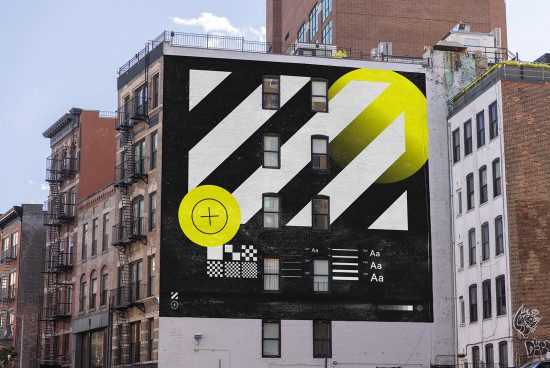 Urban building with a bold graphic mural showcasing typography and geometric shapes, great for mockup designs and templates.