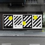 Urban billboard mockup featuring three black and white striped posters with yellow accents. Ideal for designers' advertising templates.