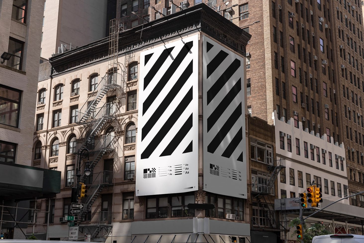 Urban billboard mockup on a building corner with black and white diagonal stripes, suited for designers to display advertising graphics.