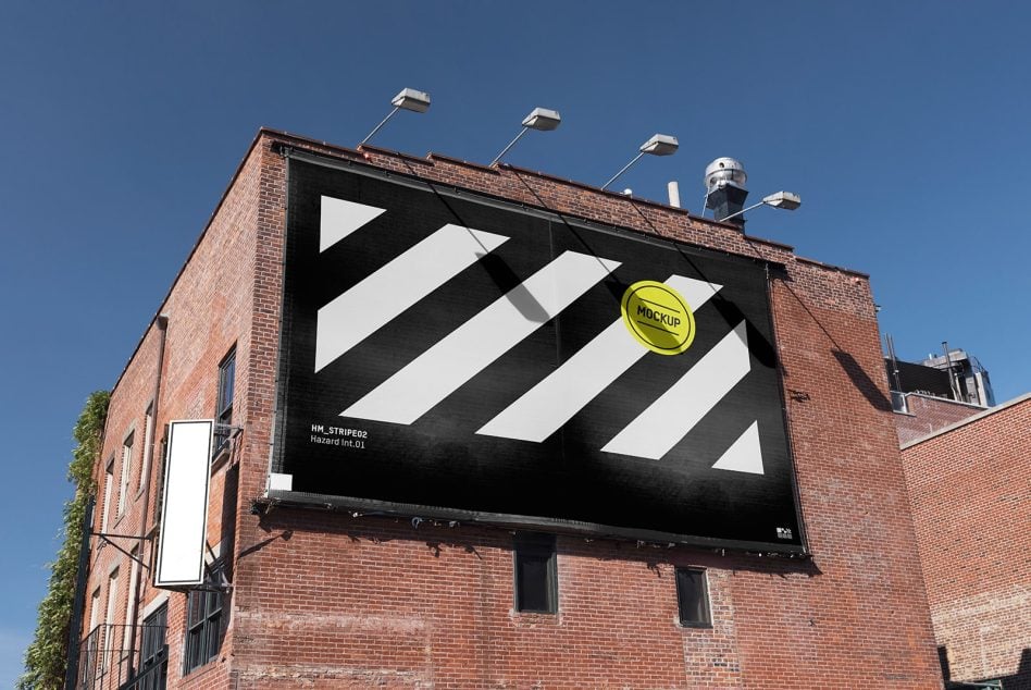 Rooftop billboard on brick building, geometric black diagonal stripes, lime yellow circle element