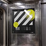 Subway train interior showing a modern poster mockup with abstract graphic design, bright yellow elements, and typography samples.