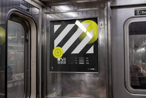 Subway train interior showing a modern poster mockup with abstract graphic design, bright yellow elements, and typography samples.