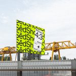 Billboard mockup displaying bright yellow design with black text, outdoor advertising, graphic designers resource, industrial backdrop.
