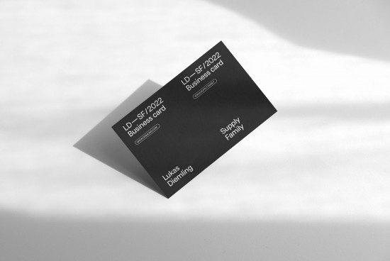 Elegant business card mockup on a textured background with natural shadows, showcasing minimalistic design for designers and branding presentations.