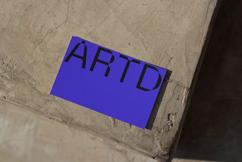 Blue paper mockup with black text on concrete floor, sunny shadow, realistic texture, design presentation, graphic designers asset.