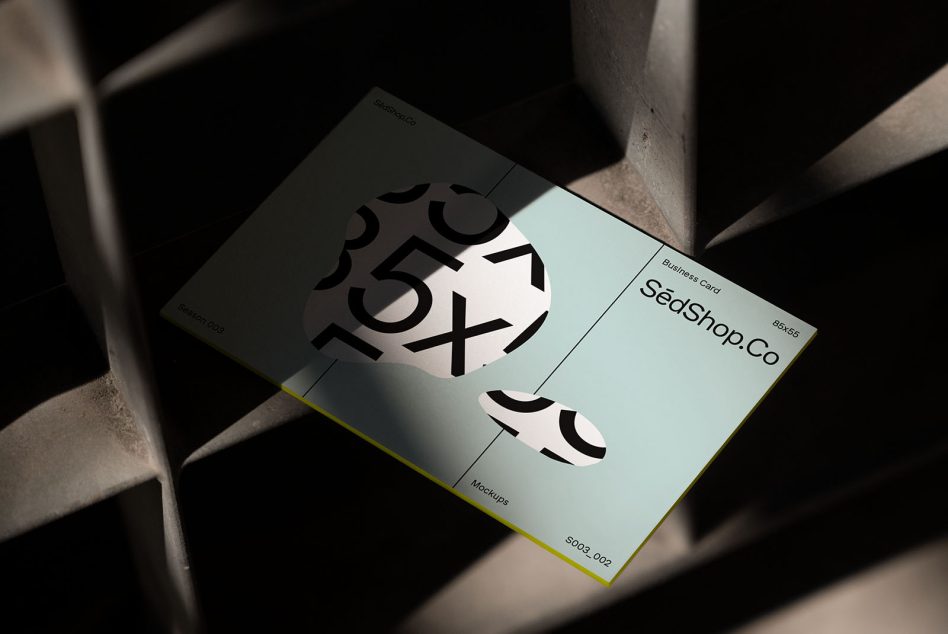 Business card mockup in pale blue with yellow edge showing typography