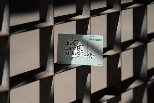 Mockup of a modern business card displayed on a metal grid background suitable for designers. Perfect for showcasing branding and print designs. Business card mockup