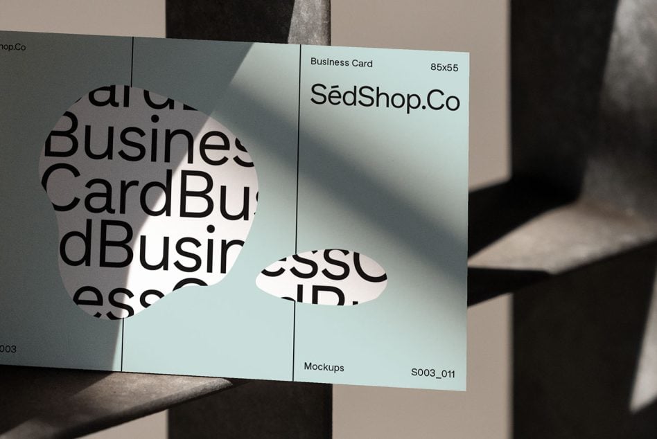 Pale blue business card mockup with circular text overlay on striped background