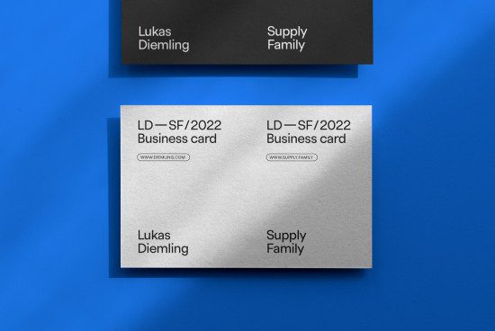 Professional business card mockup design featuring bold typography on a textured paper with contrasting blue background. Ideal for showcasing branding identity.