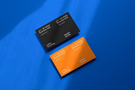Elegant business card mockup with black and orange design elements on a dynamic blue background, ideal for presentation in design portfolios.