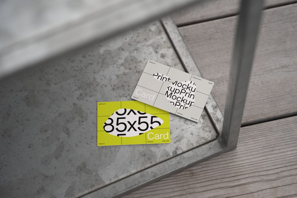 Business card mockup with contemporary design, concrete and wooden textures in a modern setting, perfect for graphic designers and branding.