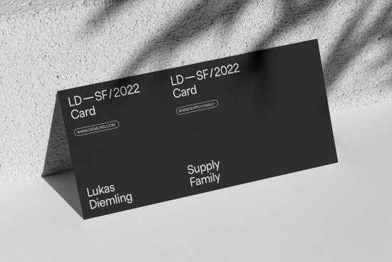 Elegant business card mockup with minimal design, lying on a textured surface for a realistic presentation, perfect for designers, print templates.