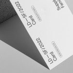 Minimalist business card mockup with textured stone, clean design layout, and shadow overlay, ideal for presentations and portfolios.