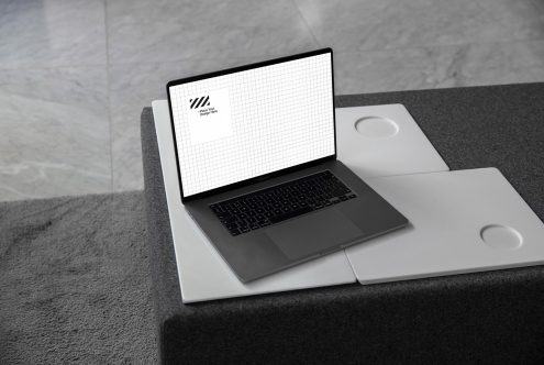 Laptop mockup on a modern desk for showcasing website designs, suitable for design templates, with grid screen, minimalist style.