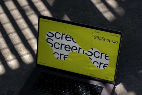 Laptop screen mockup with shadow play displaying bold font design, ideal for graphic presentations and branding visuals for designers.