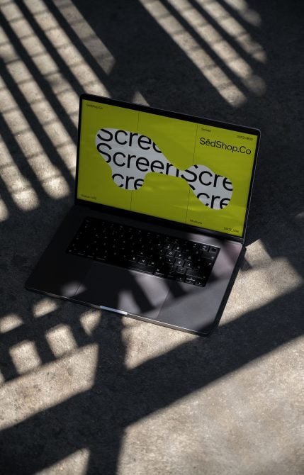 Laptop screen mockup showing neon yellow display with overlapping text layout