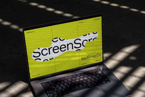 Laptop mockup on shadowy surface displaying vibrant website design, ideal for presentations, digital asset designers, realistic screen template.