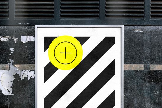 Urban poster mockup with bold graphic design, diagonal stripes and bright yellow circle, against textured city wall background for designers.