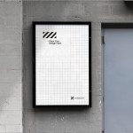 Urban poster mockup in a metal frame on a concrete wall next to a door, grid layout, customizable design presentation.