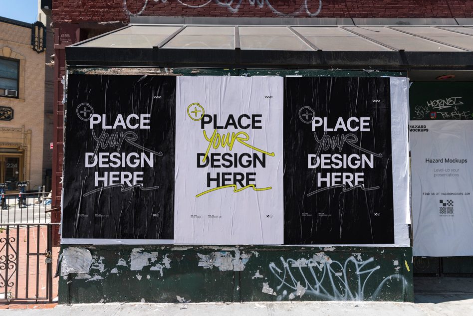 Three oversized posters mounted on vintage storefront, mixed black, white, yellow designs