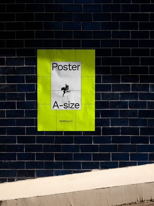 ALT: Neon yellow A-size poster mockup on a dark brick wall for a realistic presentation, ideal for designers to display graphic designs.