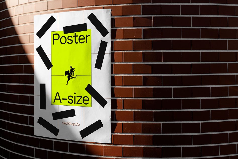 Mockup of a bright yellow A-size poster with black tape on a curved brick wall for design display, showcasing urban outdoor advertising.