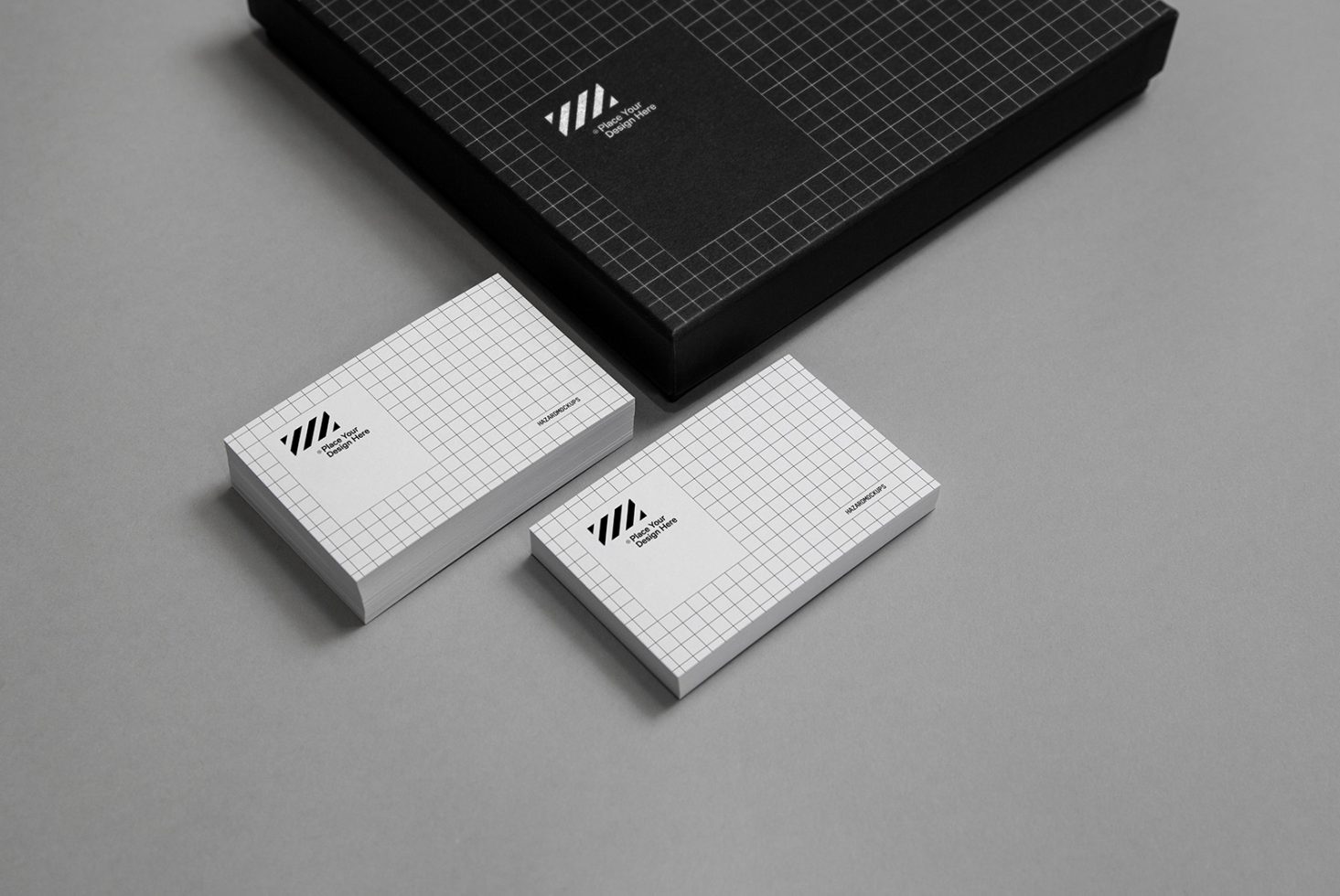 Elegant branding mockup set featuring black textured box and business cards with geometric design on a neutral background for designers.