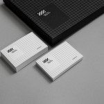 Elegant branding mockup set featuring black textured box and business cards with geometric design on a neutral background for designers.