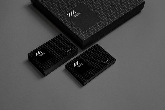 Elegant black business card and box mockup on gray background, showcasing modern branding with geometric patterns for designers.