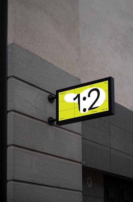 Small horizontal sign mockup with neon yellow background mounted on gray wall