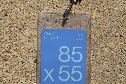 ID card mockup with lanyard on concrete background, clear plastic holder, printable badge design, event pass template, realistic graphic asset.