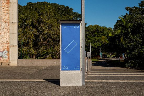 Outdoor advertising mockup featuring a tall street poster kiosk with a blue template design in an urban park setting, ideal for presenting branding work.