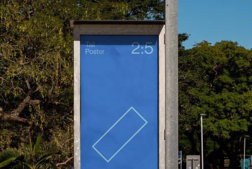 Outdoor advertising mockup of a tall, vertical poster display in a natural setting for designers to present branding graphics and ads.