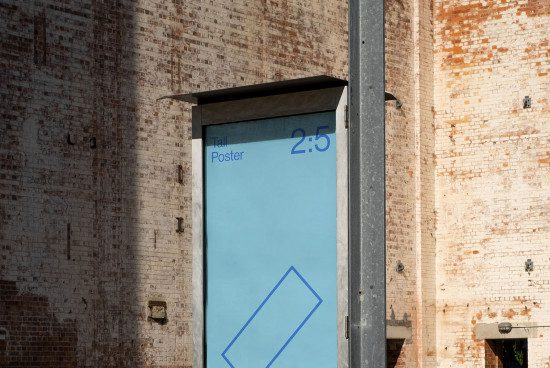 Vertical outdoor poster mockup on an old brick building facade for presentations and advertising designs among urban structures.