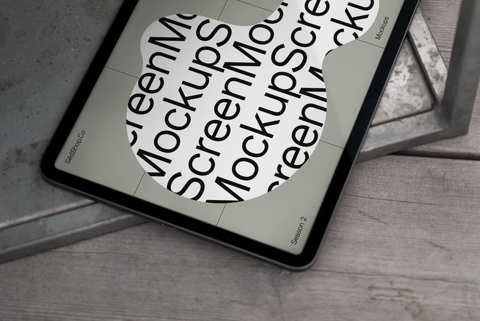 Digital tablet mockup on a concrete floor with a reflective screen showcasing design mockup text, ideal for presentation graphics.