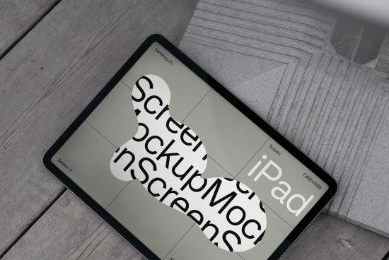 iPad screen mockup template displayed on a digital tablet lying on a wooden surface for designer portfolio presentations.