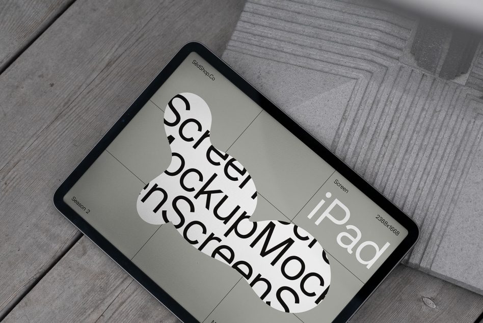 Tablet device angled overhead on grey wood boards showing layout