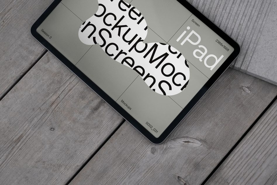 iPad mockup tilted on wooden surface displaying screen design