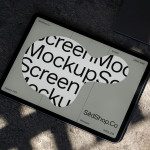 Tablet screen mockup on concrete showcasing a digital font, ideal for designers looking to present their work realistically.