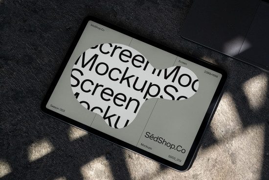Tablet screen mockup on concrete showcasing a digital font, ideal for designers looking to present their work realistically.