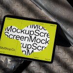 Digital tablet showcasing bold mockup design with dynamic typography on industrial background perfect for graphic designers and mockup portfolios.