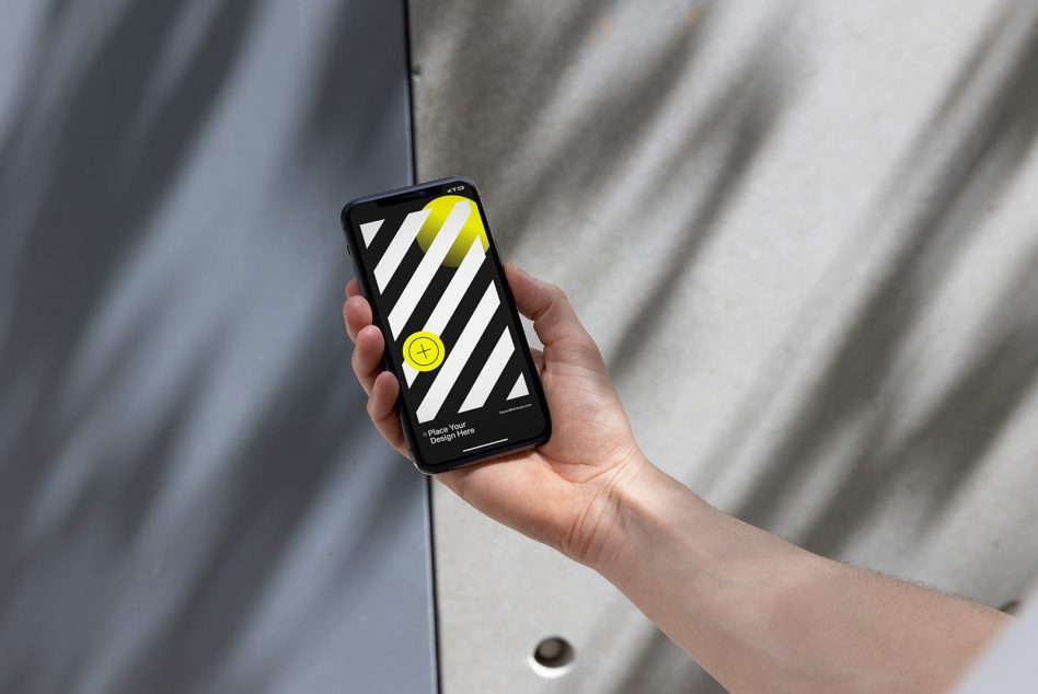 Hand holding phone showing dark screen with diagonal stripes, yellow circle badge visible