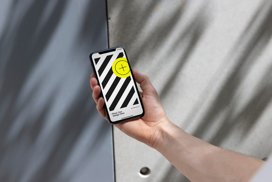 Hand holding phone displaying striped design with bright yellow circle icon on screen